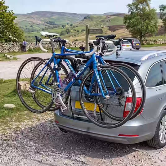 Bikes on a tailgate mounted car bike rack in a peak district car park