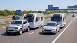 Land Rover Discovery and Skoda Octavia Estate, side by side towing caravans along the M1 motorway