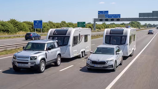 Land Rover Discovery and Skoda Octavia Estate, side by side towing caravans along the M1 motorway