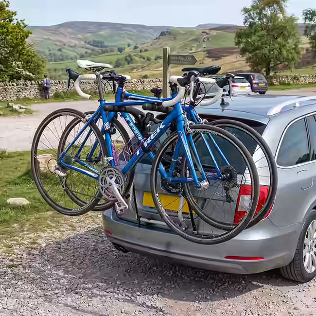 Bikes on a tailgate mounted car bike rack in a peak district car park