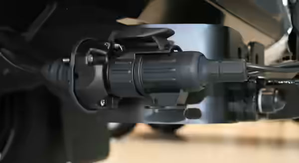 A 13-pin plug securely inserted into a towbar socket - close up